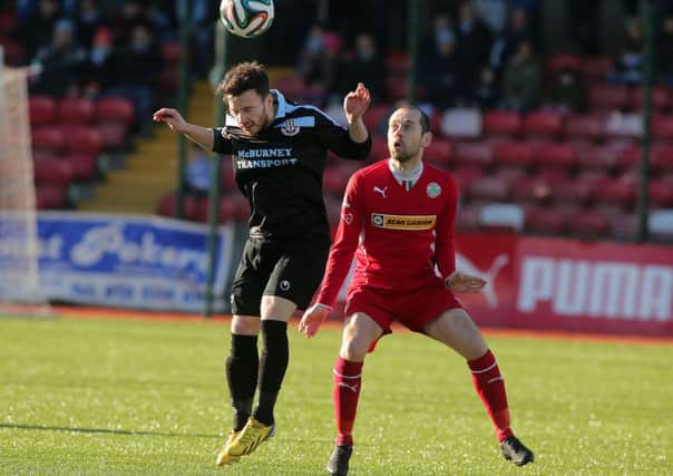 Ballymena United's Eamonn McAllister wins a header under pressure from Cliftonville's Ronan Scannell. Picture: Press Eye.
