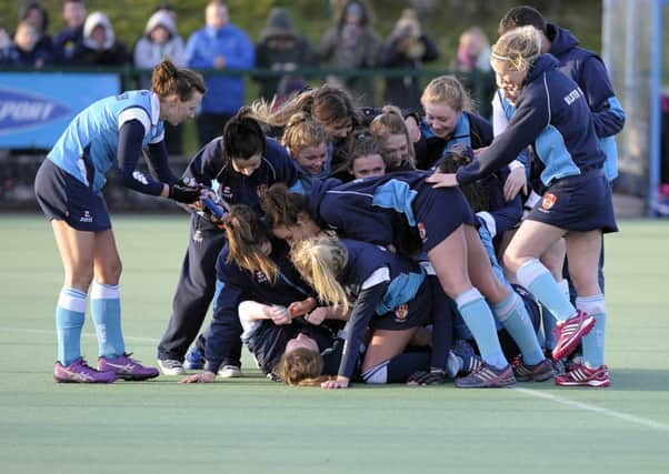 Ulster Elks' goalkeeper Rebecca Davidson mobbed by her team-mates after the win over Railway Union. Photo: Philip McCloy