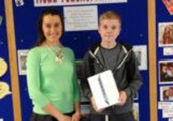 Year 10 Downshire School pupil Bradley Dubois is presented with his iPredict rail safety prize of an iPad mini by Translinks Jenna Flynn.  As well as the iPad mini, he has also won a day trip for his class on NI Railways.
Bradley was one of over 4000 people who saw the award winning iPredict show last year and entered the online competition to answer questions about rail safety based on the performance.  INCT 08-726-CON