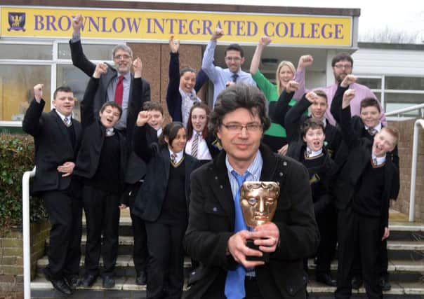 Brownlow Integrated College teacher, Ronan Blaney with his BAFTA award and pupils of his form class and staff . Staff included from left are, Mr Stephen Creber, principal; Wendy Kinley, head of drama, Daniel Wright, English teacher, Niamh Murray, English teacher, and Mark Callendar, senior teacher. INLM07-202.