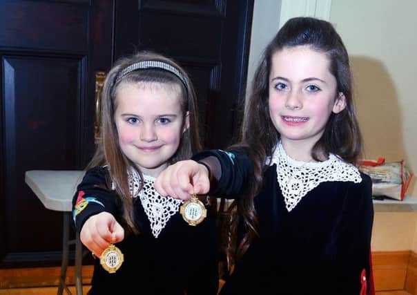Irish Dancers Abbie Gilpin and Katie Gregg of the Claire McDowell School of Dancing show of their medals won last week in the Braid Arts Centre during the dancing festival. INBT 09-803H