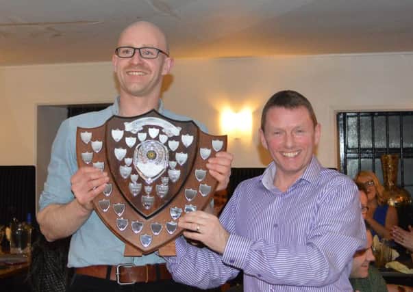 Larne AC chairman Andy Gregg (right) presents Phelim McAllister with the Athlete of the Year trophy. INLT 09-906-CON