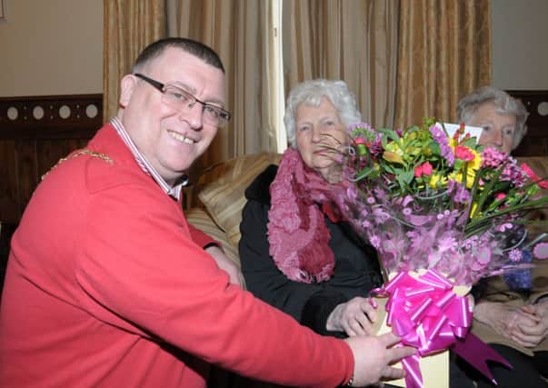 Larne Mayor, Cllr. Mark Wilson presents Jean McCullough with a bouqet of flowers to mark her 100th Birthday during her visit to the Mayor's parlour INLT 08-212-AM