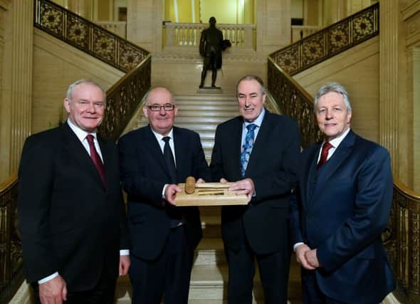 Former Speaker William Hay (second left) receives a gift of an engraved gavel from his successor Mitchel McLaughlin, flanked by Deputy First Minister Martin McGuinness and First Minister Peter Robinson