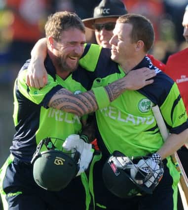 Ireland's not out batsmen John Mooney, left, and Niall O'Brien, right, embrace as they walk off after defeating West Indies during their Cricket World Cup pool B match at Nelson, New Zealand, Monday, Feb. 16, 2015. Ireland wins the match with 4 wickets and 25 balls to spare. (AP Photo/Ross Setford)