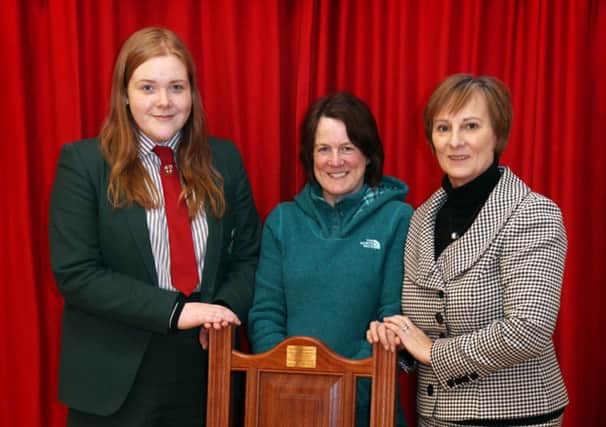 Lara Millar (Head Girl), Lulu Kane (Albert's wife) and Mrs Anne Bell (Headmistress) pictured with the chair at Coleraine High School. INCR9-373PL