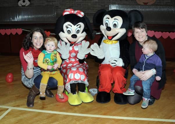 Having breakfast with Mickey and Minnie are, Kerri and Joe Denman and Claire and Grace Millar INLT 07-217-AM