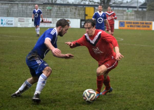 Ballyclare's Joel Cooper takes on Loughgall's Marcus Dallas. INNT 09-053-GR