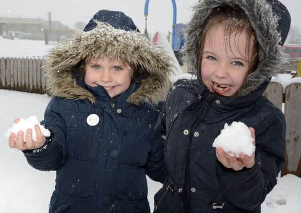 Lisnagelvin Primary School pupils Macy Anderson and Amber Nicholl enjoyed the snow yesterday. INLS0915-153KM