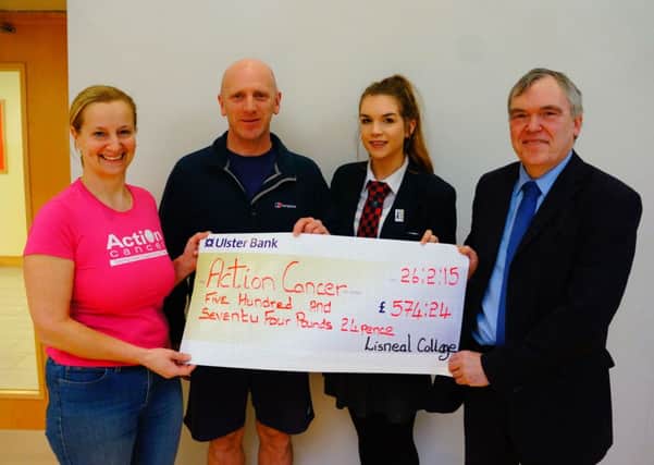 Diana Parker representing Action Cancer, receiving a cheque  for £574.24 from Keith Ferguson, the PE teacher at Lisneal College, pupil Jenny Stevenson and David Funston, headmaster at the school.