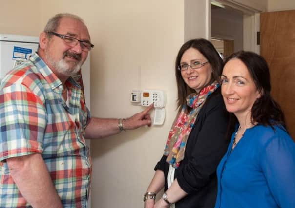 Brendan McCluskey, a tenant at Carnduff Park in Ballycastle, who is delighted with his new heating scheme. He is pictured with Housing Executive manager Breige Mullaghan and Noeleen Connolly, from the Ballycastle office. INBM11-15 heating