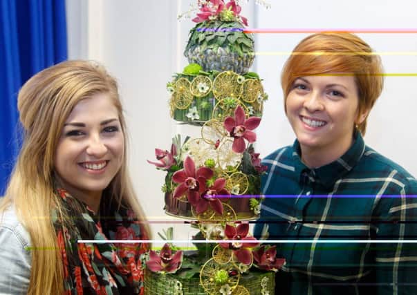 Twenty one year old Emma Sinnamon (left) from Donacloney, shows CAFRE floristry student Cherith Clarke, Waringstown, the detail of her fantastic floral cake at the British Florist Association Event helf recently at CAFRE's Greenmount Campus.