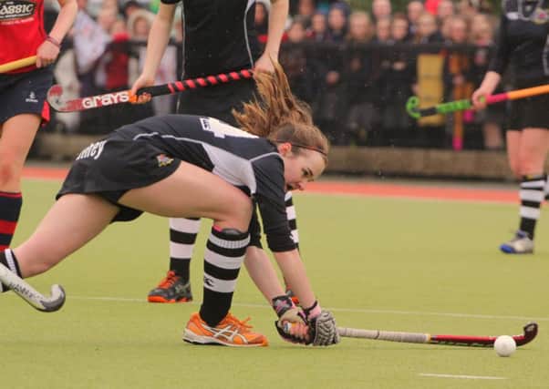 Rachel Burns reverses the ball out of the Rainey defence.