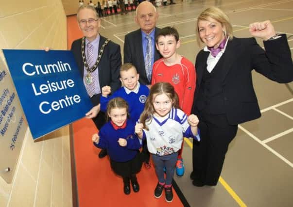 Mayor of Antrim, Councillor Brian Graham unveils the plaque at the official opening of Crumlin Leisure Centre. He is pictured with Alderman Sam Dunlop, Chair of Development and Leisure Committee, Janine Beazley, Centre Manager and representatives from Crumlin Integrated Primary School, Gaelscoil Ghleann Darach, St Joseph's Primary School and Crumlin Integrated College.