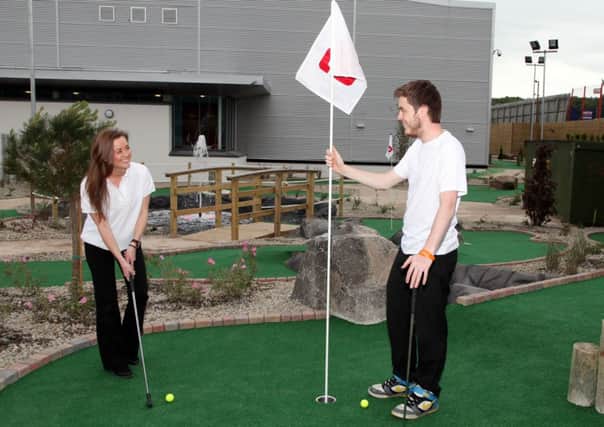 Staff members Richard McMullan and Laura Dysart enjoying a game at the new Mini Golf at the Jet Centre Coleraine.