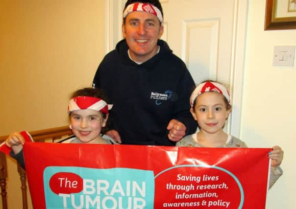 Local Runner, Jonny Graham pictured with daughters Ella and Caitlin will 'Wear it Out!' on a charity Bandana run on 6th March to raise funds and awareness for 'The Brain Tumour Charity'.