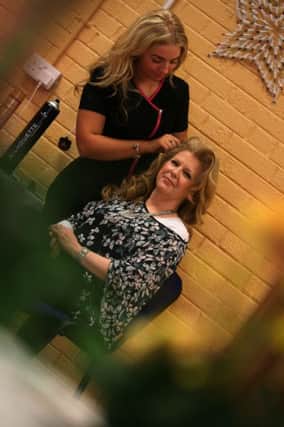 GOOD HAIR DAY. . . .A bit of pampering for Bronagh McCallion during Friday's event at Glen Community Centre. DER0915MC163