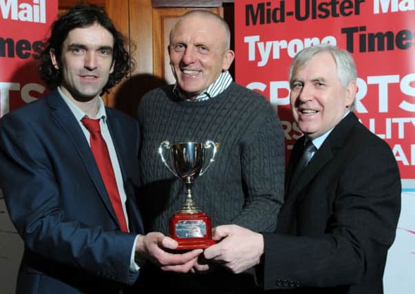 Slaughtneil GAC Chairman Sean McGuigan receives the Mid-Ulster Mail and Tyrone Times team of year award from Michael McGlade (Editor) and Kevin Hughes (Head of Sport).INTT1015-428