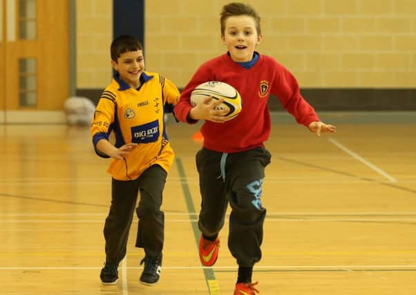 Joshua Keene of Ballykeel Primary School and Gabriel Comsa of St Brigid's Primary School take part in rugby coaching with Ballymena RFC at Ballymena North. INBT 11-171CS