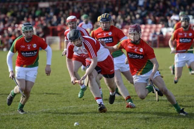 Derry's Alan Grant and Carlow's Alan Corcoran tussle for the ball. DER1015-146KM
