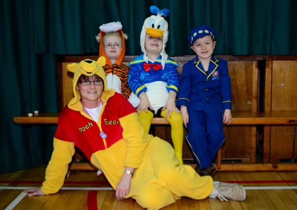 Hannah, Jack, Lucas and Mrs Flemming dressed as their favourite book characters for Earlview Primary School's World Book Day celebration. INNT 10-023-GR