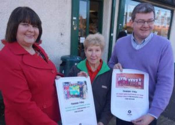 Staff from the Grand Street Spar store in Lisburn recently collected £600 for Oxfam Ireland. Looking on are  Anne Currie and manager Ian Parker and June Hewitt (left), manager of Oxfams Lisburn shop.