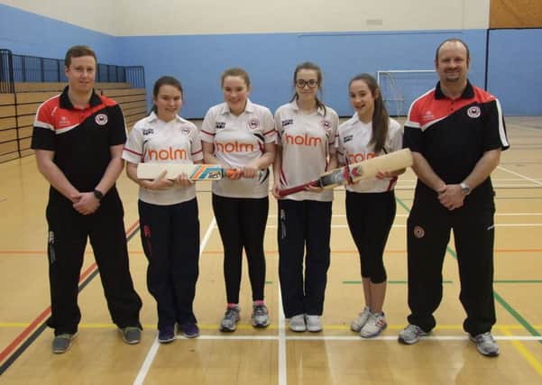 Some of the girls' under-13s squad with coaches Mark Thompson and Artie Campbell at the Newtownabbey Cricket Winter Academy.