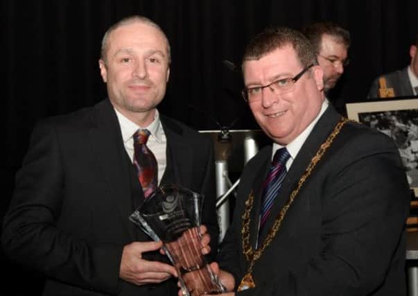 Larne Mayor Martin Wilson presents ex-Northern Ireland international Michael Hughes with his award after he was inducted into Larne's Sporting Hall of Fame. INLT 11-908-CON