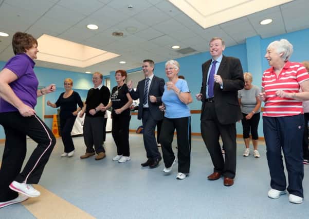 Alderman Paul Porter, Chairman of the Council's Leisure Services Committee and Jeff Scroggie, Health Development Specialist, SEHSCT join in at an 'Active Aging' exercise class at the Lagan Valley LeisurePlex.