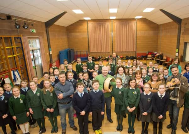 Banbridge District Council Good Relations Officer Dolores Donnelly (centre) at Moyallon Primary School with the music and dance workshop team. Also pictured are teachers and pupils from Moyallon, St. John's, Gilford, and Milltown primary schools.