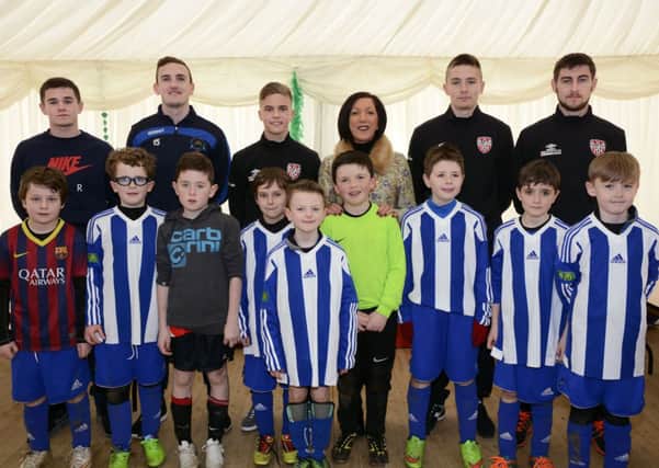 The Culmore team which competed in the under-10's football competition during the Waterside St. Patrick's Day weekend at Lisnagelvin, included are, from left, Michael McCrudden, Stephen O'Donnell, Institute, Joshua Daniels, Derry City, the Mayor, Councillor Brenda Stevenson, Ryan Curran and Aaron Barry, Derry City. INLS1115-154KM