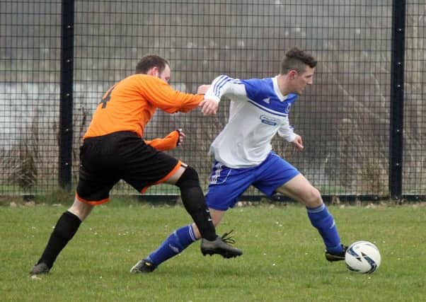A Ballykeel player bursts past his Connor opponent during Saturday's match. INBT 12-930H