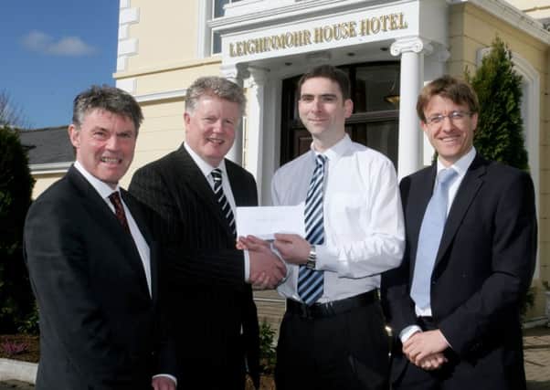Adrian Fullan, of Leighinmohr House Hotel, presents a new sponsorship deal to Wakehurst FC chairman Billy Erwin. Included are Wakehurst manager Ian Gregg and club captain Douglas Stevenson. INBT 12-236AC