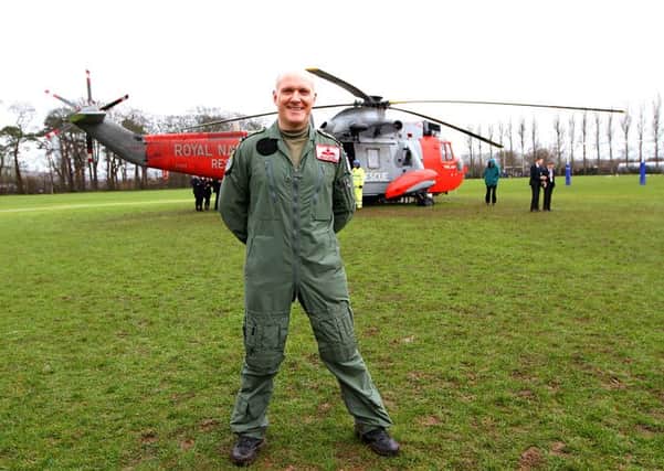 Operations officer Stuart 'Butch' Cassidy, helicopter pilot with the Royal Navy flew his aicraft into his former school Limavady Grammar this week were he was welcomed by all the present day pupils. INLV1115-033KDR