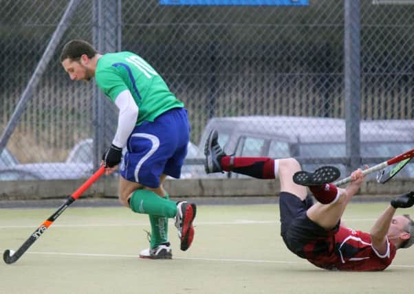 A Ballymena player break forward as an Armagh opponent stumbles during Saturday's match at the Showgrounds. INBT 12-916H