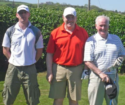 SUNSHIE. Ruairi Bonnar, Eamon McIlroy and Terry McNamara soak up the sunshine at Ballycastle Golf Club on Saturday.INBM22-12 9081F.