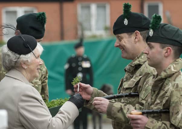 Royal Irish Regiment soldiers receive shamrock from Lord Lieutenant of Antrim Mrs Joan Christie. INNT-11-700-con