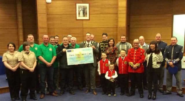 The Mayor Cllr Andrew Ewing was presented with a Cheque for £600 for the Mayors Charity Marie Curie by 1st Maze Northern Ireland Supporters Club..The Club recently held a Battle of the Bands Fundraiser in Lower Broomhedge Orange Hall.