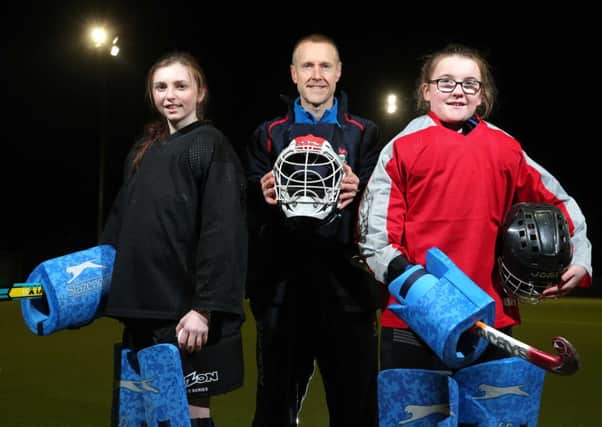 Raymond Geddis, Business Manager at Danske Bank with players Cara McEwen from Moira and Sarah OHare from Hillsborough.