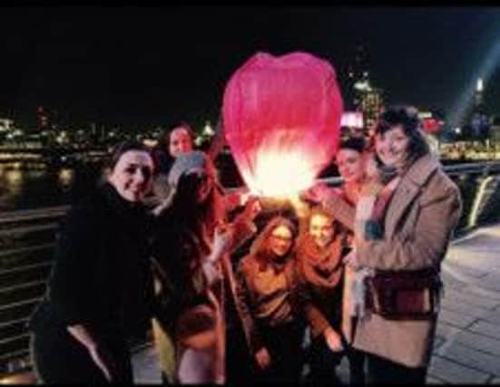 Friends of Lisa Orsi, who paid tribute to her by releasing lanterns from a bridge in London.