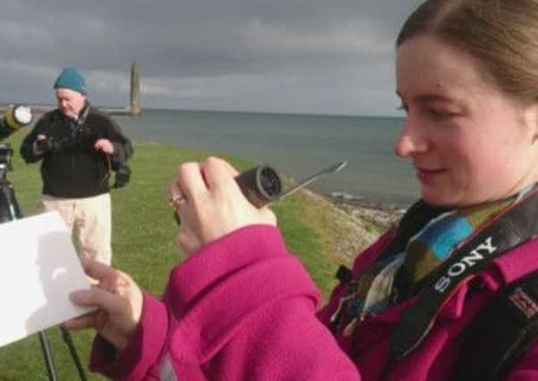 Heather Murray watches the solar eclipse at Sandy Bay, Larne.  INLT 11-675-CON