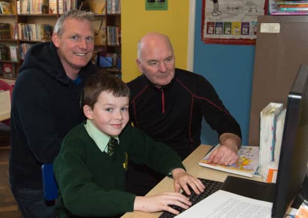 Winner of the Young Sports Journalist competition, Tannaghmore Primary School pupil Thomas Turbitt with teacher Kevin Creevy and  Eugene Craney. INLM1315-400