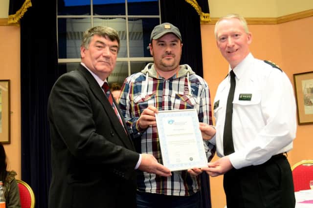 Councillor Noel Williams, chair of Carrickfergus PCSP and Chief Inspector Stephen Reid with Michael Clarke from Sunnylands/Woodburn Youth Project. INCT 12-048-GR
