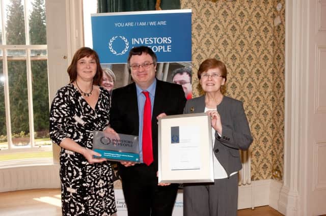 Employment and Learning Minister Dr Stephen Farry with Glynis Long and Mary Gourley, from Carrickfergus Citizens Advice Bureau, which is celebrating Investors in People (IiP) accreditation. INCT 12-703-CON CAB