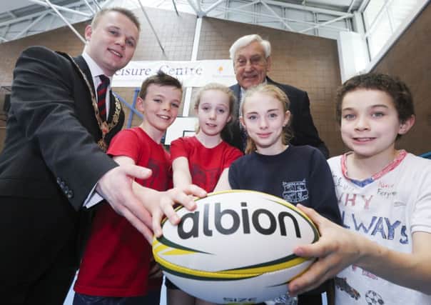 Mayor Thomas Hogg and former Lions and Ireland rugby captain, Dr Willie John McBride MBE pictured with P7 pupils Zachary Scarlett and Rebecca Parke (Fairview Primary School), and Holly McMahon and Kieren Ferguson (Tir na nOg Primary School) at Sixmile Leisure Centre.
