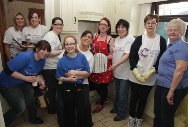 HAPPY HELPERS. Iris (3rd right), pictured with her merry band of helpers for the Cancer Research UK Big Breakfast on Satruday.INBM12-15 074SC.