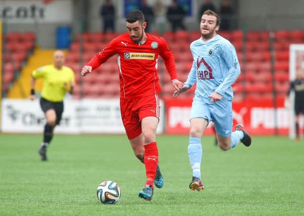 Cliftonville striker Joe Gormley races away from Institute's Aaron Walsh during Saturday's match. Picture by Kevin Scott/Presseye