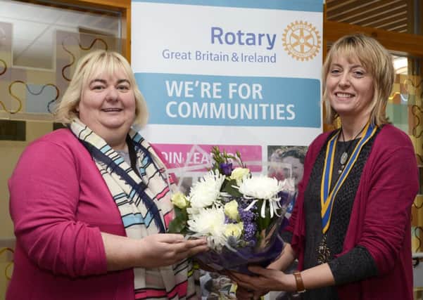 Helen McDonnell, President of the Londonderry Rotary Club, pictured making a presentation to Catherine Cooke, of the Foyle Women's Information Network, who was the runner-up in the Rotary Ireland Unsung Heroine of the Year Award. INLS1315-112KM