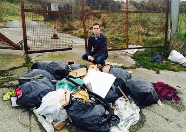 Councillor Gary Middleton beside some of the dumped rubbish.