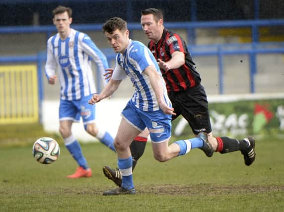 Coleraine's Shane McGinty in action with Crusaders Barry Molloy. Photograph:Stephen Hamilton/Presseye